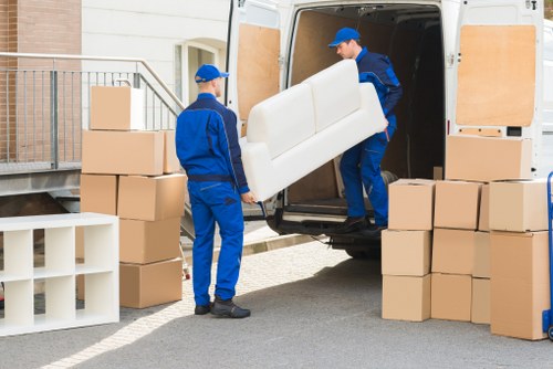 Moving team loading goods carefully into a van