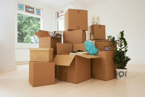 Professional movers carrying household items during a Wood Green relocation